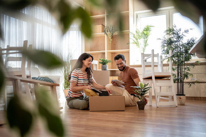 Couple unpacking boxes in new home